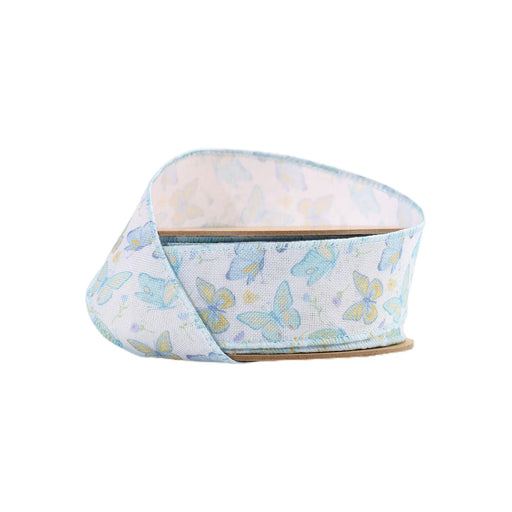 The 1.5 White and Blue Butterflies Ribbon (9331W-029-38E) features light blue and yellow butterflies on a white background, beautifully wound in a loop with one end slightly raised, ready for your next creative project.