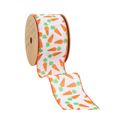 A partially unrolled spool of 2.5 White with Orange Carrots Ribbon 9409W-029-63E, decorated with vibrant orange carrots and green leaves, elegantly rests on a brown cardboard reel.