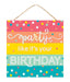 The 10Sq Glitter Party/Birthday Sign Pastel Multi AP783061 features vivid stripes in pink, orange, yellow, green, and blue with Party like its your BIRTHDAY in white. The backdrop is dotted with multicolored polka dots for lively pastel décor and hangs by a rope.
