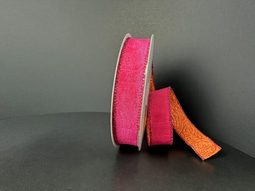 A spool of 7/8X10Y ribbon featuring double-sided Fuchsia Dupioni and Orange Glitter Embossed designs (D61532-05-28) stands upright against a plain, dark background.