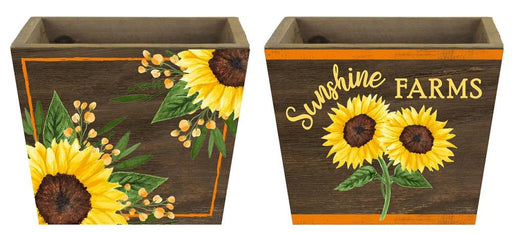 Set of two 5.75 square x 4.25H Sunflower Planters in Yellow, Moss, Brown, and Orange (KM1138). Each features painted sunflower and leaf designs with Sunshine FARMS text in a 2 Assorted style.