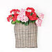 The 11 by 13.5 by 4 Curvy Basket M21202IEI is shown filled with red and pink artificial flowers, set against a plain white background.