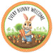 The 12 DIA Orange Brown Green Blue White Black Metal Every Bunny Welcome Sign (MD1529) features a cute bunny in overalls with carrots amidst a carrot garden. Topped with Every Bunny Welcome, its orange and green dotted border makes it a charming home or garden addition.