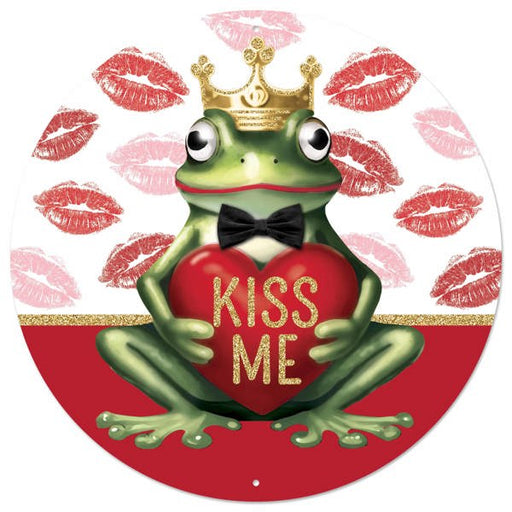 Illustration of a frog in a gold crown and bow tie, holding a heart with KISS ME, with red lipstick kiss marks in the background, inspired by the 12 DIA Red/White/Green/Gold Metal Kiss Me Frog Prince Sign MD154924.