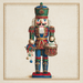 The 10 x 10 Nutcracker Soldier Christmas Sign (TTE-321) features a colorful nutcracker in a decorative uniform with a tall green hat, holding a drum and ornaments, set against a plain vintage-style background.