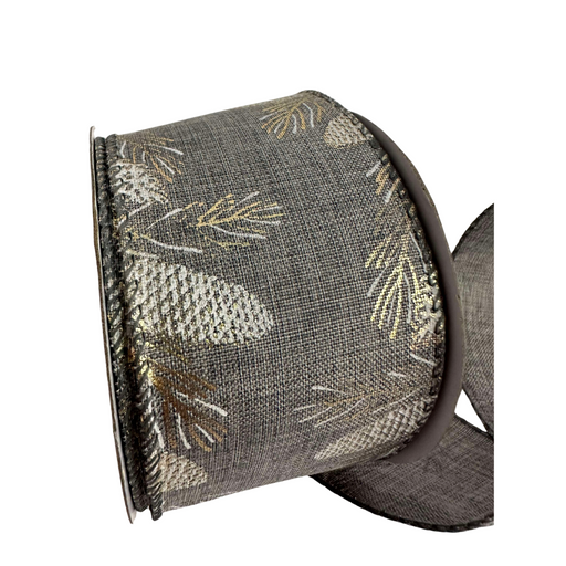 The 2.5 Gray Burlap with Golden Pinecones Ribbon R32927 features dark gray burlap with metallic silver and gold pinecone and leaf patterns, partially unrolled to showcase its textured design, ideal for crafts or gift wrapping.