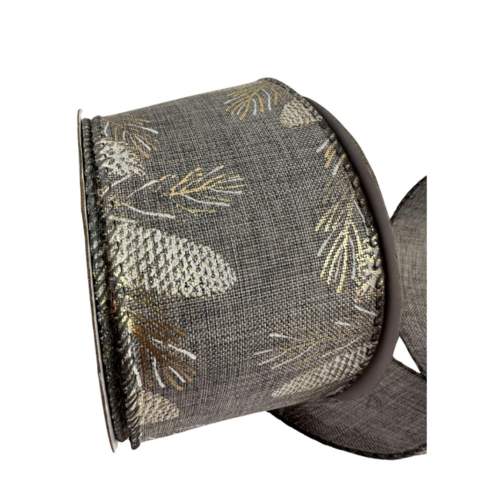 The 2.5 Gray Burlap with Golden Pinecones Ribbon R32927 features dark gray burlap with metallic silver and gold pinecone and leaf patterns, partially unrolled to showcase its textured design, ideal for crafts or gift wrapping.
