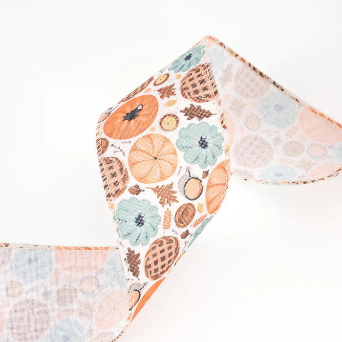 The 2.5 Natural and Multi Pumpkin Frenzy Wired Ribbon (WR-10367-063-10) features orange pumpkins, blue flowers, and brown pies on a white background with natural multi fall colors, curled in a loose wave.