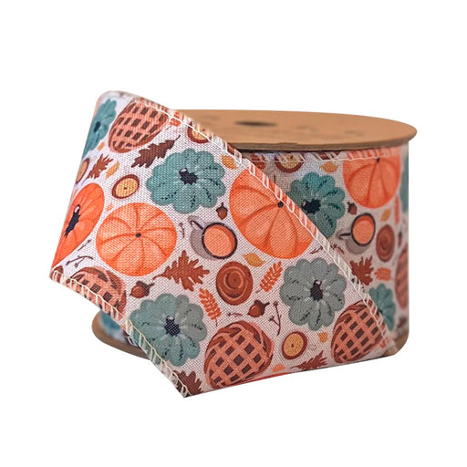 A spool of 2.5 Natural and Multi Pumpkin Frenzy Wired Ribbon (WR-10367-063-10) is partially unrolled, displaying its festive autumn pattern with pumpkins, pies, leaves, and acorns in vibrant seasonal colors.