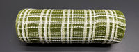 A rolled-up piece of 10X10Y Moss Jute-Cream Fuzz Plaid Mesh XB105210-08 rests on a smooth, dark surface. This jute-like material has a green and white plaid grid pattern that creates a textured look.