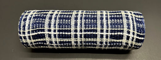 A roll of 10X10Y Navy Jute-Cream Fuzz Plaid Mesh (XB105210-27) is displayed on a smooth black surface.