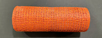 A 10X10Y Rust Orange Textured Weave Mesh (XB253510-31) sits on a dark surface, its intricate pattern and vibrant rust-orange color clearly visible.