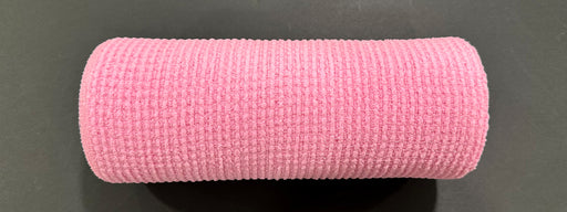 The 10X10Y Pink All Snow Fuzz Mesh XB253610-03, featuring a textured, grid-like surface, is shown lying on a black background.