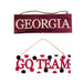 The Red Black Georgia or Go Team Assorted Wall Hanging (AP809899) features two MDF wooden signs: a maroon GEORGIA in white letters, and a white GO TEAM with red/black polka dots and bold red text. Both signs are suspended by a cord for an energetic decor accent.