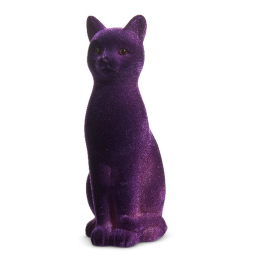 The 11" Flocked Cat 4540848 is a small, purple figurine with upright ears and a soft velvet texture, making it a charming Halloween decoration for any space.