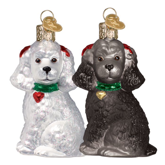 The Assorted Poodle (A) Ornament by Old World Christmas (12152) features two blown-glass dog ornaments—one white, one black—with red ears, green collars, and gold heart tags, bringing charming detail to your holiday décor.