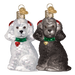 The Assorted Poodle (A) Ornament by Old World Christmas (12152) features two blown-glass dog ornaments—one white, one black—with red ears, green collars, and gold heart tags, bringing charming detail to your holiday décor.