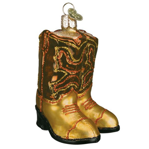 The Brown Pair Of Cowboy Boots Ornament by Old World Christmas (32494) is a festive tree decoration shaped like cowboy boots, featuring red decorative patterns and a loop for hanging.