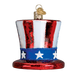 Show your patriotic spirit with the 36206 Uncle Sams Hat Ornament by Old World Christmas, a glass decoration featuring red, white, and blue stripes, white stars on a blue band, and a gold hanging loop.