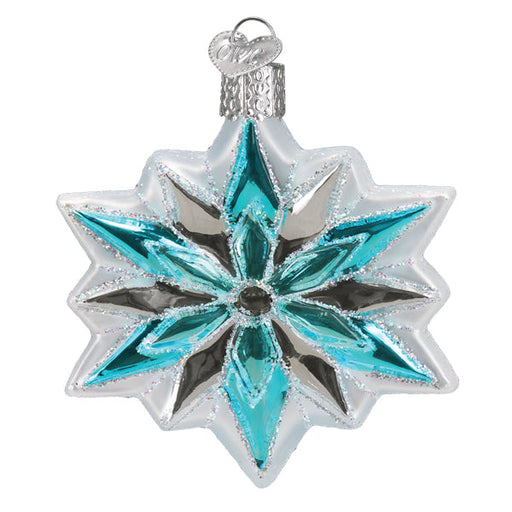 Introducing the Snowflake Ornament 36313 from Old World Christmas: a star-shaped glass Christmas decoration featuring silver and teal accents, intricate snowflake-like patterns, and glittery embellishments. It is expertly crafted in the Old World Christmas tradition and comes with a small silver cap for easy hanging.