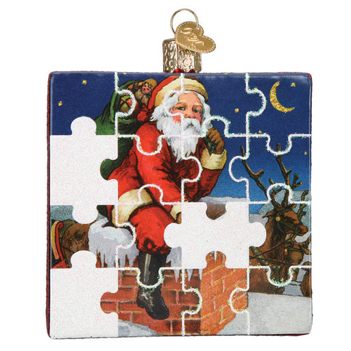 Santa Jigsaw Puzzle Ornament by Old World Christmas (44180): Features Santa in a red suit with a green sack climbing down a chimney and reveals a reindeer under a crescent moon. Comes with a golden top loop for hanging.