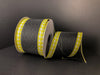 The 2.5X10Y Black Linen/Yellow-White Gingham Edge ribbon (45216-40-49) is elegantly unrolled on a dark surface, with the solid black background accentuating its design.