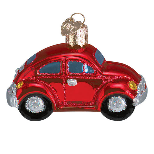 The Red Buggy Ornament by Old World Christmas (46110) is a classic VW Beetle-shaped glass piece with hand-painted red hues, blue windows, silver accents, black wheels, and a gold loop for hanging.