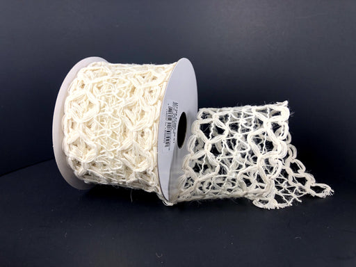 A spool of 2.5X10Y White Hex Open Weave Ribbon 47386-40-01 featuring a hexagonal pattern is placed on a dark surface, with some of the trim unrolled and displayed in front.