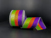 A 2.5x10Y Lime-Orange-Purple Glitter Stripe ribbon with black-white dash edge (55107-40-11), displayed against a black background.