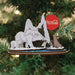 The Polar Bears on Ice CCO115 Old World Christmas Ornament features polar bears, a penguin, and a seal. One bear holds a Coca-Cola bottle with the red logo visible in the snowy backdrop—an ideal addition to your festive collection.