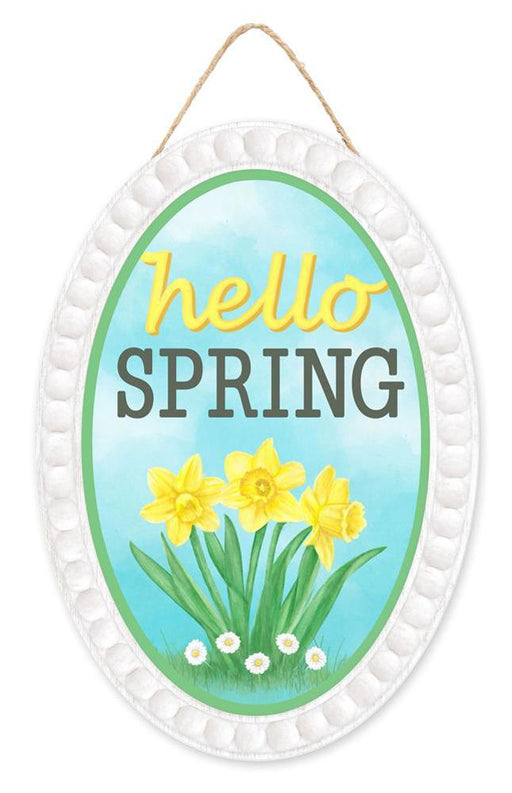 The 13Hx9L Hello Spring Oval Sign (AP7261) is made of MDF/paper with a white border, featuring yellow daffodils and hello SPRING text in yellow and black on an ice blue background. It includes a twine loop for easy hanging.