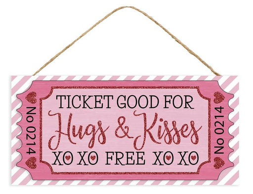 The 12.5L Glitter Ticket Hugs & Kisses Sign (AP7843) in pink/light pink/black/white is a decorative plaque shaped like a glitter ticket, featuring Ticket Good For Hugs & Kisses XO XO FREE XO XO on a striped background with heart accents and an attached rope for easy hanging.