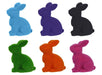 Six 10x8.25 flocked sitting rabbit figurines made of polystyrene and nylon come in assorted colors: purple, pink, black, green, orange, and turquoise. The rabbits sit facing left in two rows of three.