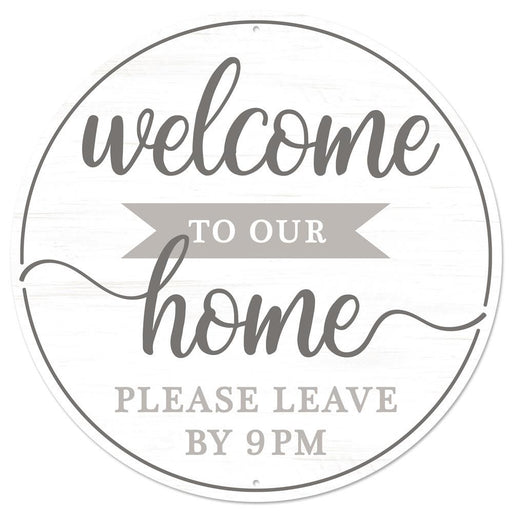 The 12 diameter round metal sign MD0905 features the text Welcome to Our Home, please leave by 9pm in gray, charcoal, and white, with the word home stylized in larger cursive font.