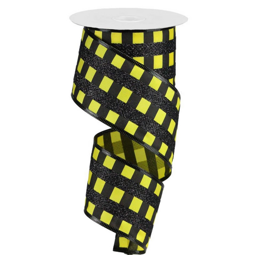 The 2.5 Yellow Black Glitter Stripes on Satin Ribbon (RG882529) features diagonal yellow accents with dazzling glitter. Partially unrolled, its spiral shape enhances the elegance of any project.