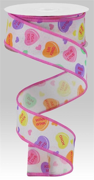 A 1.5 x 10 yd spool of Conversation Hearts on Royal Ribbon in White/Multi (RGA149027) with sweet messages like TRUE LOVE, XOXO, and KISS ME—unspooled in a loose spiral, ideal for festive decorating.