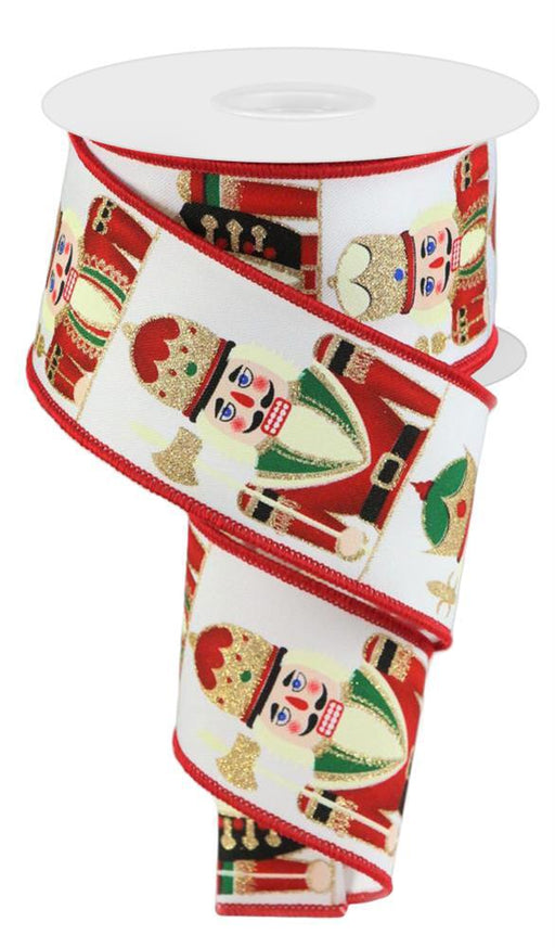 A 2.5X10Yd Nutcracker ribbon spool (RGC156827) in white with red, green, blue, and black accents features colorful nutcracker designs.
