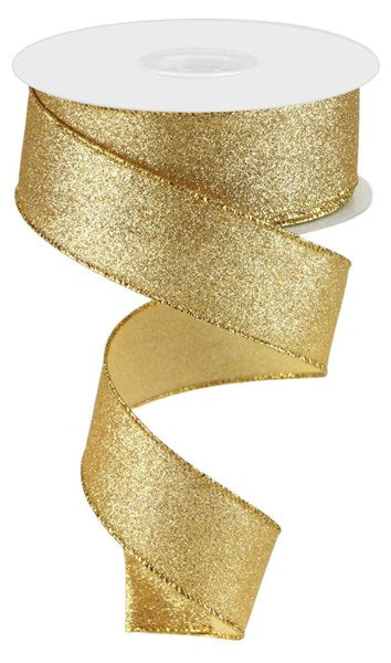 A spool of 1.5X10Yd Shimmer Glitter Gold RGC159608 ribbon features a wide, sparkling gold band, ideal as wired ribbon for elegant gift wrapping or décor against a white backdrop.