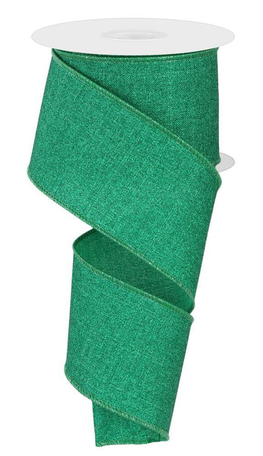 A partially unrolled spool of 2.5X10Yd Fine Glitter On Royal Jadeite ribbon (RGE1381T4) in green, featuring wired edges and a glittery finish.
