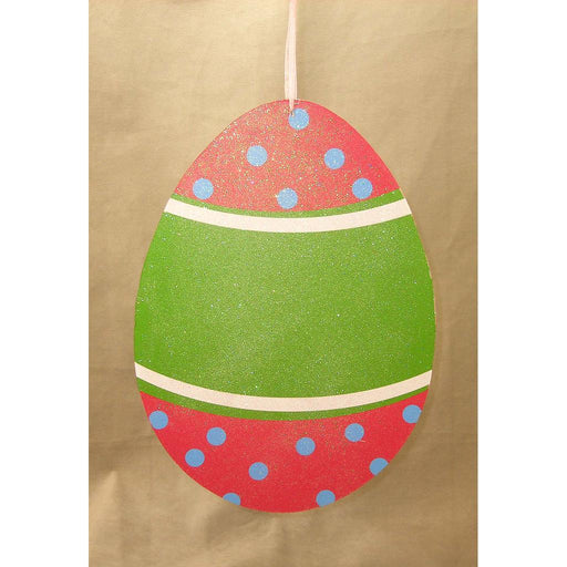 A decorative 11.5 by 8.75 hanging Easter egg ornament with a glittery finish features red and green horizontal sections, adorned with blue polka dots on the red parts, and thin white lines separating the sections on a solid, light gold background, ideal for an elegant pink and green display.