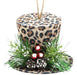 The 5Dia Leopard Print Hat Ornament (Tan/Black/Brown XJ4346) features faux pine branches, mini pine cones, red berries, and white accents in brown, black, and tan tones, hanging by a brown string.