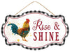 Labeled AP7083, this 12.5x7.5 sign features a checkered black and white border, a colorful rooster on the left, and Rise & Shine in bold red on a white background. It hangs elegantly by a thin rope.