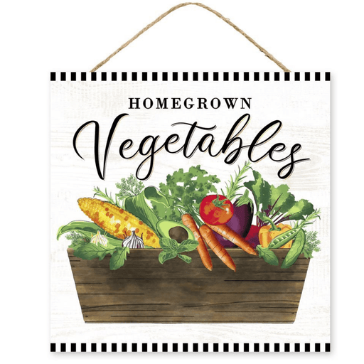 An illustration of a wooden basket overflowing with vibrant vegetables like corn, carrots, tomatoes, garlic, and greens. Homegrown Vegetables is written in elegant script on the rustic MDF 10 Homegrown Vegetable Sign AP7100 with a hanging rope.