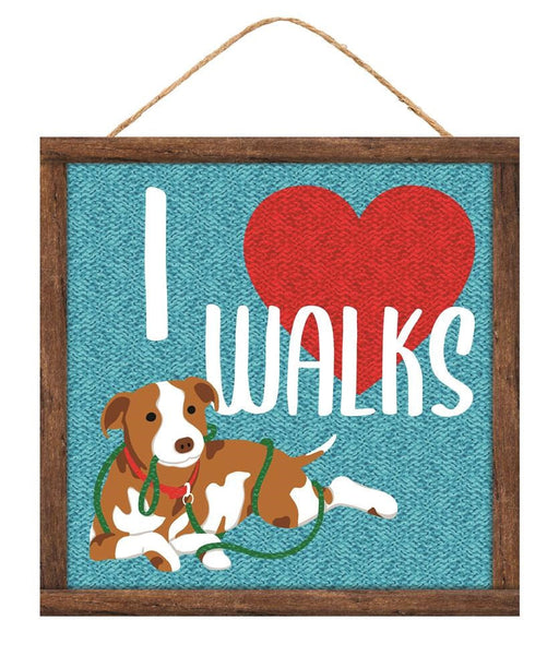 The 10 Square I Heart Dog Walks Sign (AP7128) showcases a playful brown and white dog with a green leash against a blue textured background. A red heart emphasizes the text I ❤️ WALKS, making it ideal for dog walk enthusiasts and perfect as wall decor.
