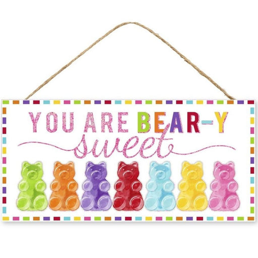 The 12.5 You Are My Bear-Y Sweet Glitter Sign (AP8856) features playful pink text and vibrant gummy bear illustrations in various colors, set against a multicolored border. Crafted from durable MDF, it offers long-lasting charm.