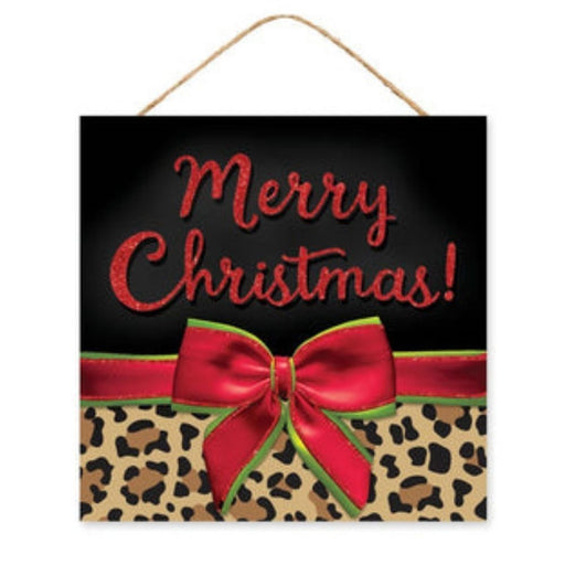 The 10"Sq Leopard Print Merry Christmas Sign (AP8946) brings festive cheer with its glittery red lettering on a sleek black background. A vibrant leopard print design is highlighted by a red ribbon and green-edged bow beneath it. This striking sign hangs gracefully by a thin rope.