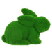 The 8.5L X 6H Flocked Laying Rabbit boasts a green hue like grass or moss, with a flocked soft texture. Crafted from polystyrene and nylon, it features rounded shapes forming the body, head, ears, and tail. Available in 6 colors: purple, pink, black, green, orange, and turquoise.