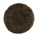 The 7 Brown Flower Center MD037004 is a circular and compact disc of dark dried tea leaves, resembling a sunflower center from above. It has a coarse texture with small leaf fragments and a uniform deep brown color indicating rich fermentation.