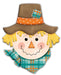 This 12H x 10L embossed scarecrow features a cheerful cartoon design with a smiling face, stitched mouth, rosy cheeks, and a triangular orange nose. It sports a brown hat with an orange polka-dotted band and patch, along with a plaid scarf—ideal for scarecrow decor.