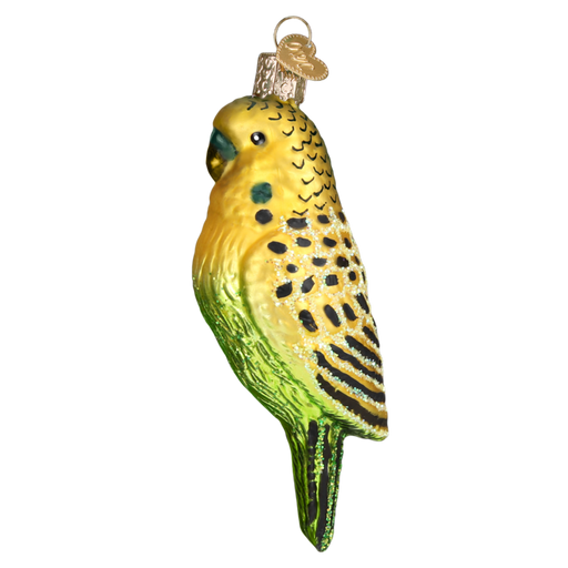 The Miniature Parakeet 16123 Old World Christmas Ornament is crafted from mouth-blown glass, featuring a yellow head and green body with intricately hand-painted black and yellow details. It's equipped with a gold cap for easy hanging, adding charm to any setting.